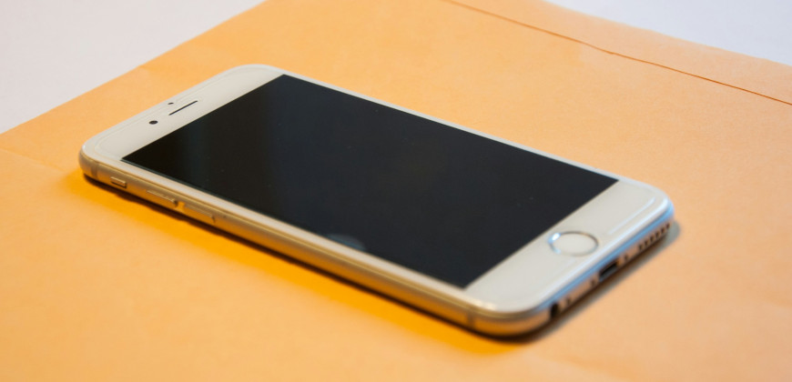 Mobile phone on an orange folder